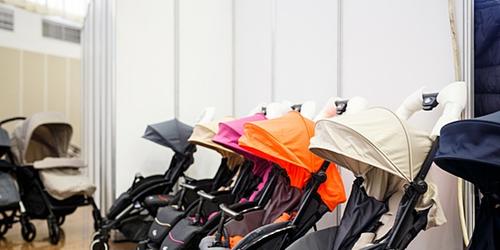 row of colourful prams in a shop