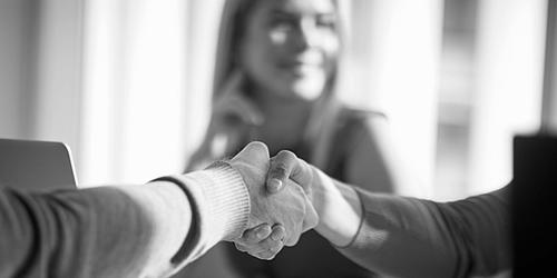a photograph of two hands amidst a handshake